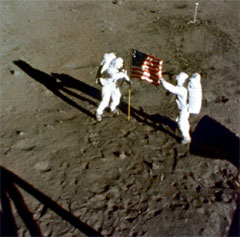 Astronauts Neil Armstrong and Edwin (Buzz) Aldrin bicker over who gets to plant the flag